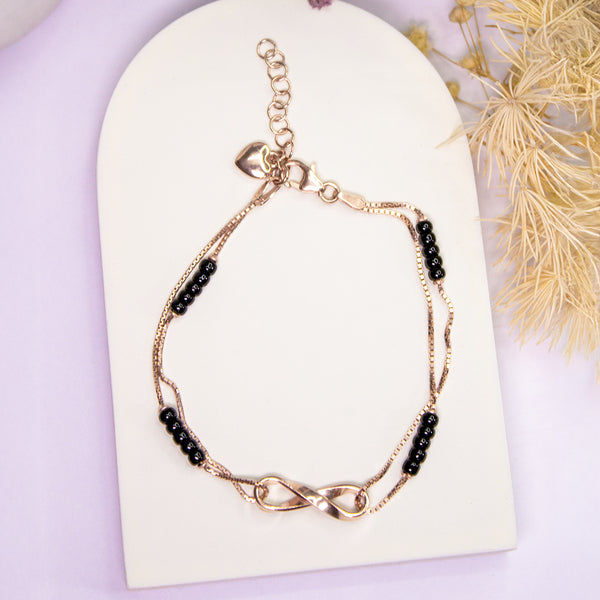 Elegant Rose Gold Infinity Bracelet with Black Beads